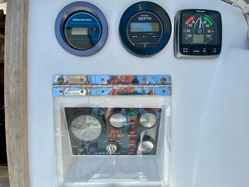 Slide: The Image of Control panel of a 1979 Valiant 37 sailboat with speed, depth, and engine gauges. - 21