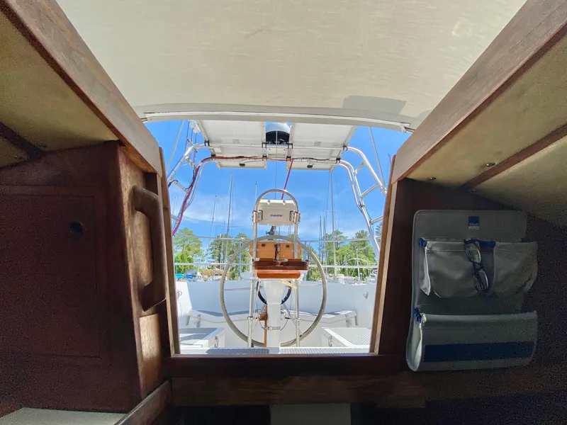 Slide: The Image of 1979 Valiant 37 sailboat cockpit view with steering wheel and clear blue sky. - 23