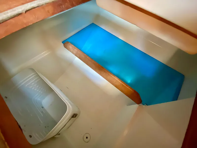 Slide: The Image of 1979 Valiant 37 interior storage compartment with blue cover and white container. - 26
