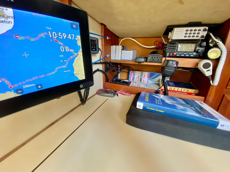 Slide: The Image of Navigation station on 1979 Valiant 37 sailboat with GPS and communication equipment. - 28
