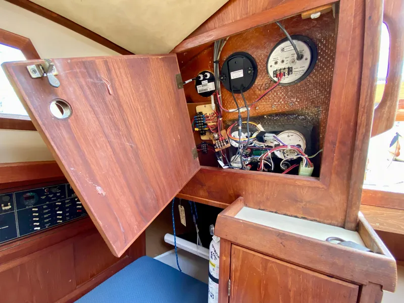 Slide: The Image of Electrical panel inside a 1979 Valiant 37 sailboat, showcasing wiring and gauges. - 32
