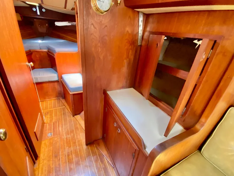 Slide: The Image of 1979 Valiant 37 yacht interior with wooden cabinetry and cozy seating area. - 39