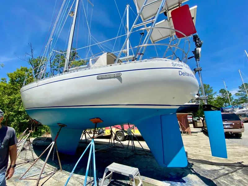 Slide: The Image of 1979 Valiant 37 sailboat on stands, blue hull, sunny day, marina background. - 4