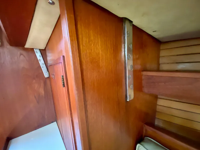 Slide: The Image of Interior view of a 1979 Valiant 37 sailboat, showcasing wooden cabinetry and metal fixtures. - 40