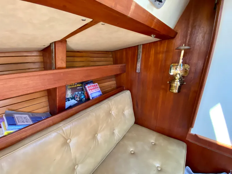 Slide: The Image of Cozy interior of 1979 Valiant 37 sailboat with books and vintage lamp. - 42