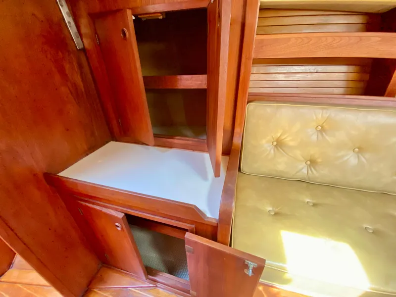 Slide: The Image of 1979 Valiant 37 interior with wooden cabinets and cushioned seating. - 43