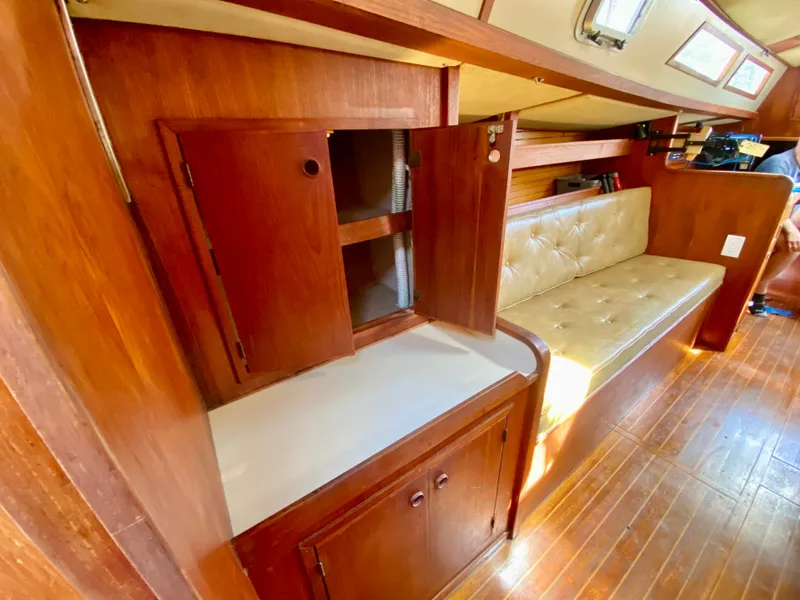 Slide: The Image of 1979 Valiant 37 interior with wooden cabinetry and cushioned seating. - 45