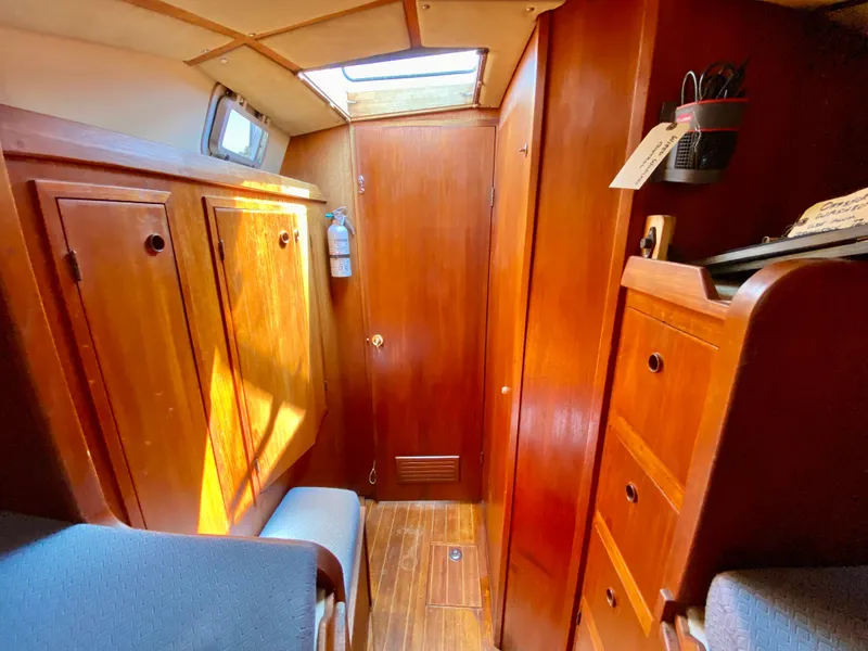 Slide: The Image of Interior of 1979 Valiant 37 sailboat with wooden cabinetry and natural light. - 48