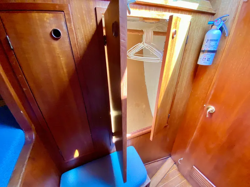 Slide: The Image of 1979 Valiant 37 sailboat interior with wooden cabinets and fire extinguisher. - 49