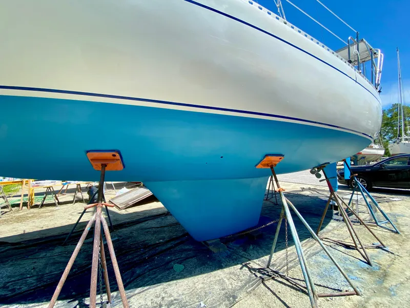 Slide: The Image of 1979 Valiant 37 sailboat on stands, blue hull, sunny day. - 5