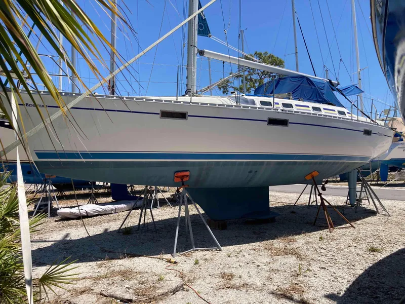 The Image of 1993 Beneteau Oceanis 370 sailboat on stands, viewed from the side, under clear blue sky. - 0