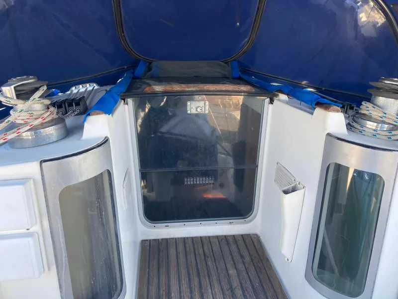 Slide: The Image of Cockpit of 1993 Beneteau Oceanis 370 sailboat with blue canopy and wooden flooring. - 12