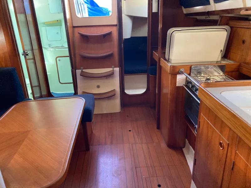 Slide: The Image of Interior of 1993 Beneteau Oceanis 370 sailboat with wood finish and compact kitchen. - 16