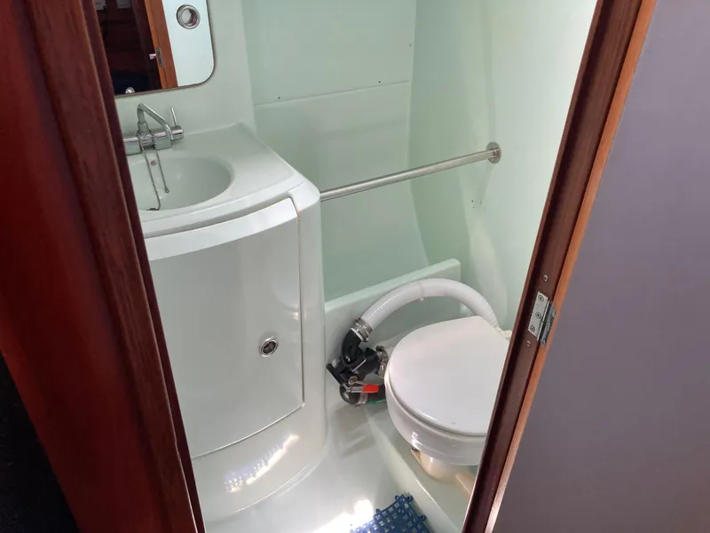 Slide: The Image of Bathroom interior of 1993 Beneteau Oceanis 370 sailboat, featuring sink and toilet. - 18