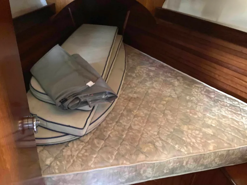 Slide: The Image of Cozy cabin bed in 1993 Beneteau Oceanis 370 sailboat with cushions and bedding. - 20