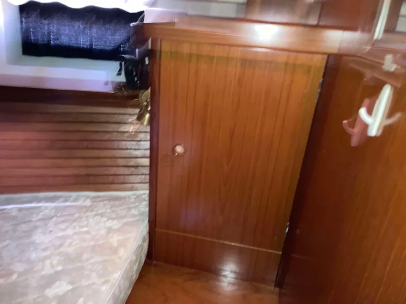 Slide: The Image of Cabin interior of 1993 Beneteau Oceanis 370 with wooden paneling and mattress. - 21