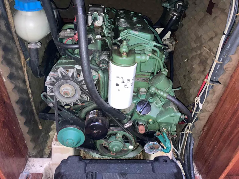 Slide: The Image of Engine compartment of a 1993 Beneteau Oceanis 370 sailboat, showcasing mechanical components. - 22