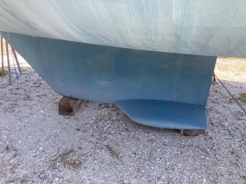 Slide: The Image of 1993 Beneteau Oceanis 370 sailboat keel on dry land, supported by wooden blocks. - 26