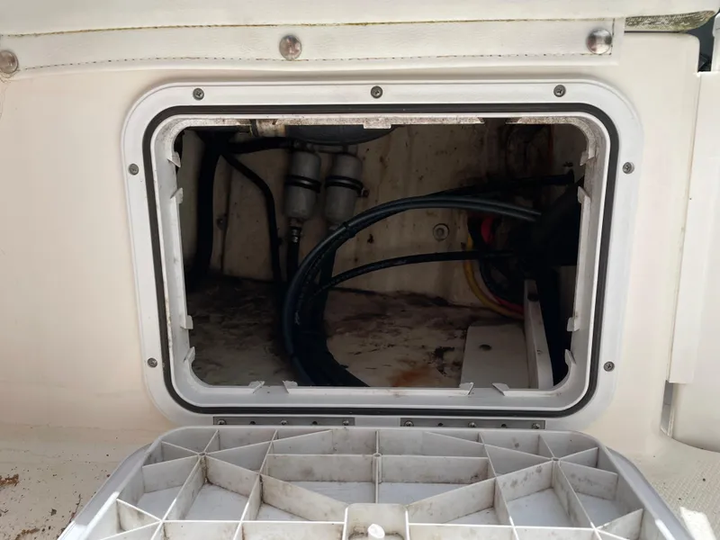 Slide: The Image of Open hatch of a 2015 Edgewater 188CC boat showing internal wiring and components. - 11