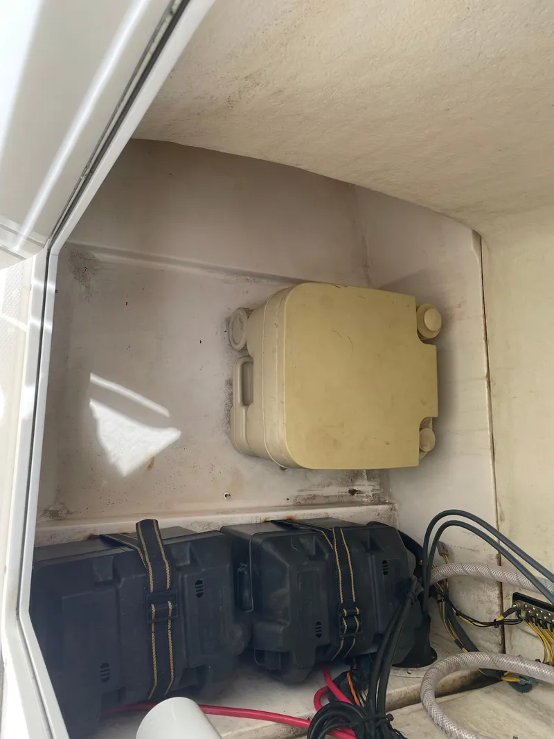 Slide: The Image of 2015 Edgewater 188CC boat battery compartment with wiring and storage. - 5
