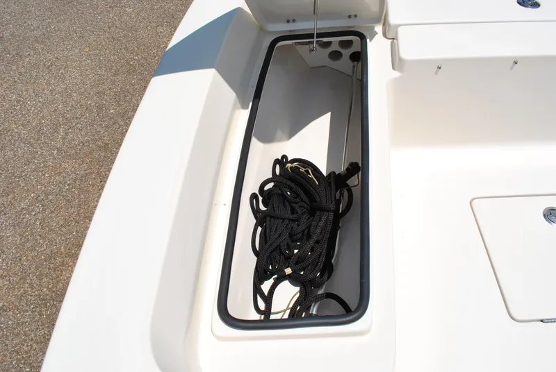Slide: The Image of Storage compartment with coiled rope on 2010 Pathfinder 2400 Tournament Edition boat. - 12