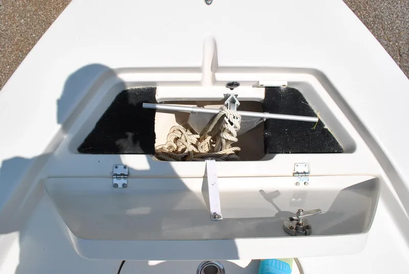 Slide: The Image of 2010 Pathfinder 2400 Tournament Edition boat storage compartment with anchor and rope. - 14