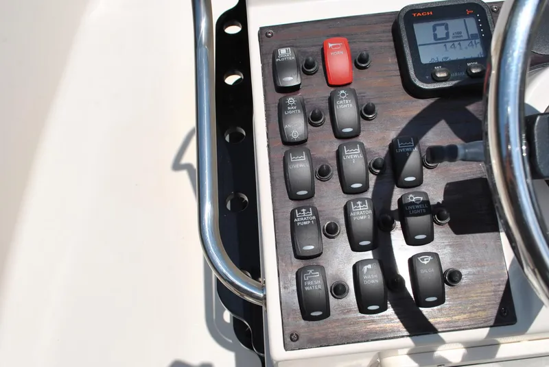Slide: The Image of Control panel of a 2010 Pathfinder 2400 Tournament Edition boat with switches and a digital display. - 21