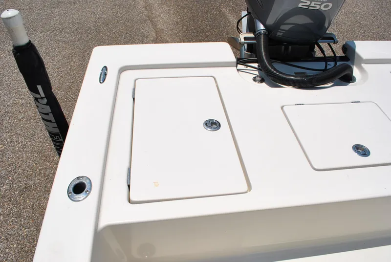 Slide: The Image of 2010 Pathfinder 2400 Tournament Edition boat deck with storage compartments and motor. - 26