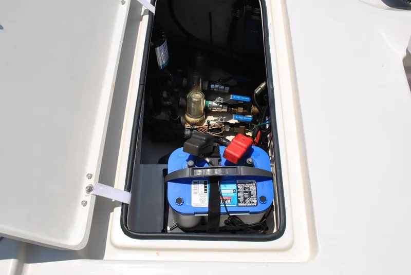 Slide: The Image of 2010 Pathfinder 2400 Tournament Edition boat battery compartment with wiring and components. - 29