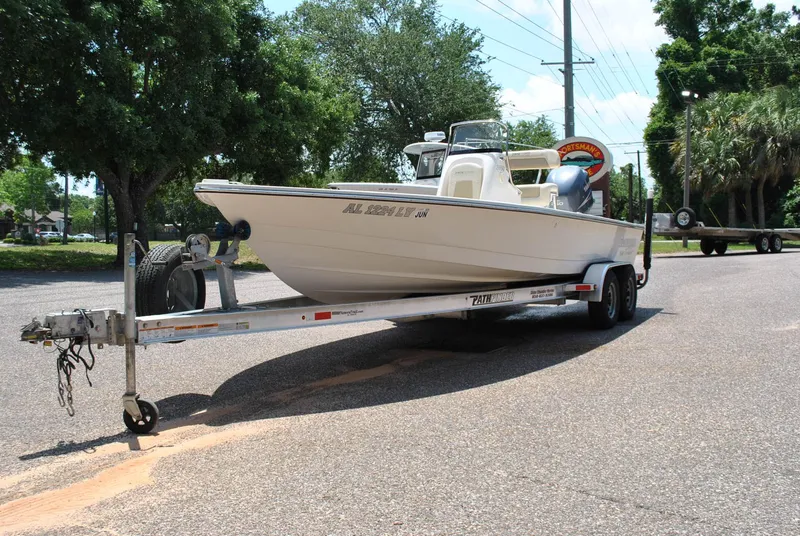 Slide: The Image of 2010 Pathfinder 2400 Tournament Edition boat on trailer, parked on a sunny street. - 3