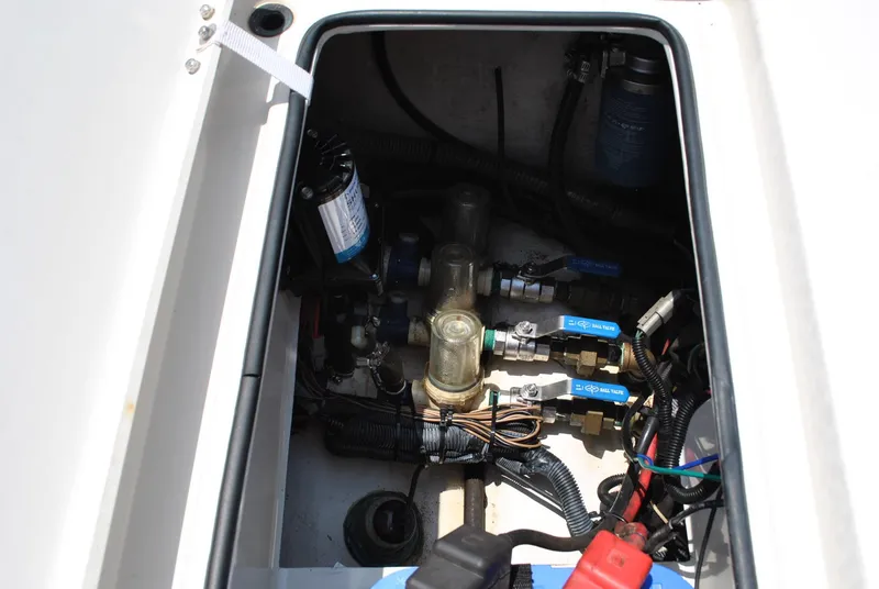Slide: The Image of Electrical and plumbing components inside a 2010 Pathfinder 2400 Tournament Edition boat. - 30