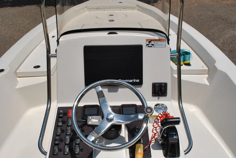 Slide: The Image of Steering console of 2010 Pathfinder 2400 Tournament Edition boat with controls and navigation equipment. - 33