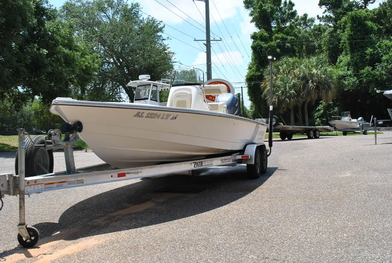 Slide: The Image of 2010 Pathfinder 2400 Tournament Edition boat on trailer, parked outdoors. - 4