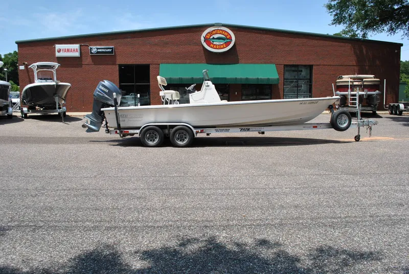 Slide: The Image of 2010 Pathfinder 2400 Tournament Edition boat on trailer outside dealership. - 7