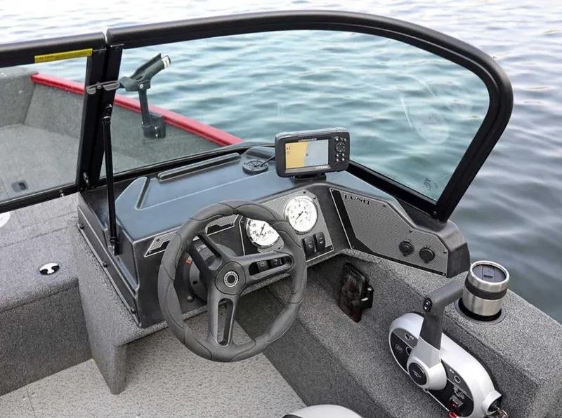 Slide: The Image of 2026 Lund 1650 Angler boat dashboard with steering wheel and navigation system on water. - 5