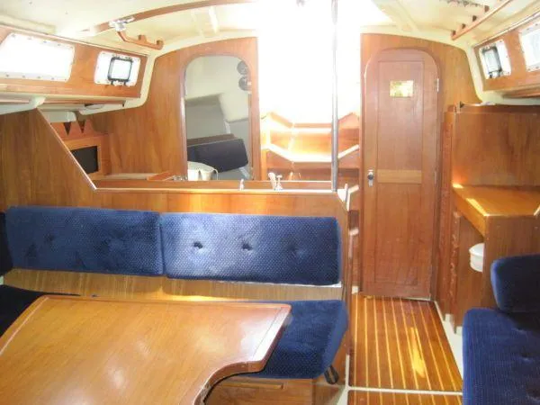 Slide: The Image of Interior of 1986 Pearson 36-2 sailboat with wooden furnishings and blue upholstery. - 10