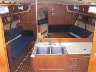 Slide: The Image of Interior of 1986 Pearson 36-2 sailboat with wood finish and blue seating. - 12