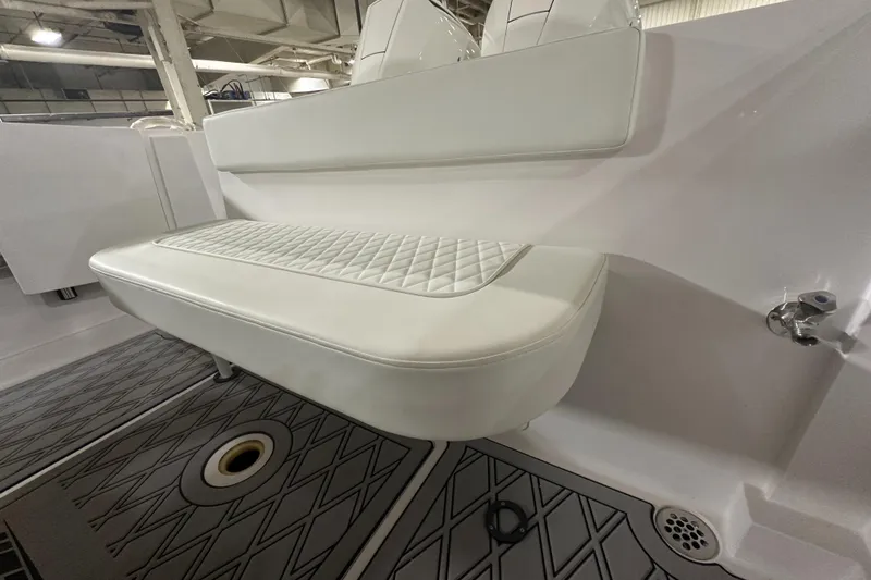 Slide: The Image of 2026 Hustler 288 CC boat interior with cushioned seating and non-slip flooring. - 12