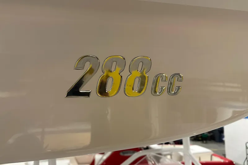 Slide: The Image of 2026 Hustler 288 CC boat emblem on hull. - 16