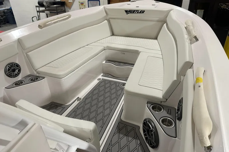 Slide: The Image of 2026 Hustler 288 CC boat interior with white seating and modern design. - 17