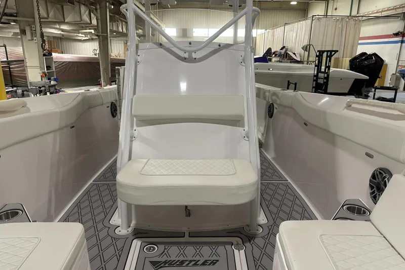 Slide: The Image of 2026 Hustler 288 CC boat interior with white seating and modern design. - 19