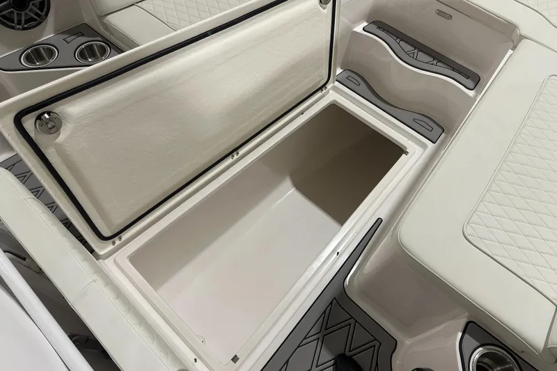 Slide: The Image of Open storage compartment in 2026 Hustler 288 CC boat interior. - 21