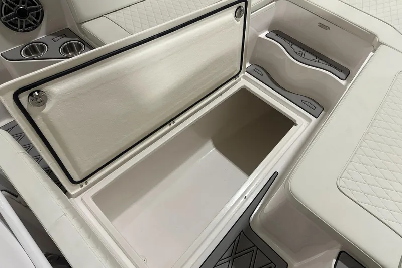 Slide: The Image of Open storage compartment in 2026 Hustler 288 CC boat interior. - 22