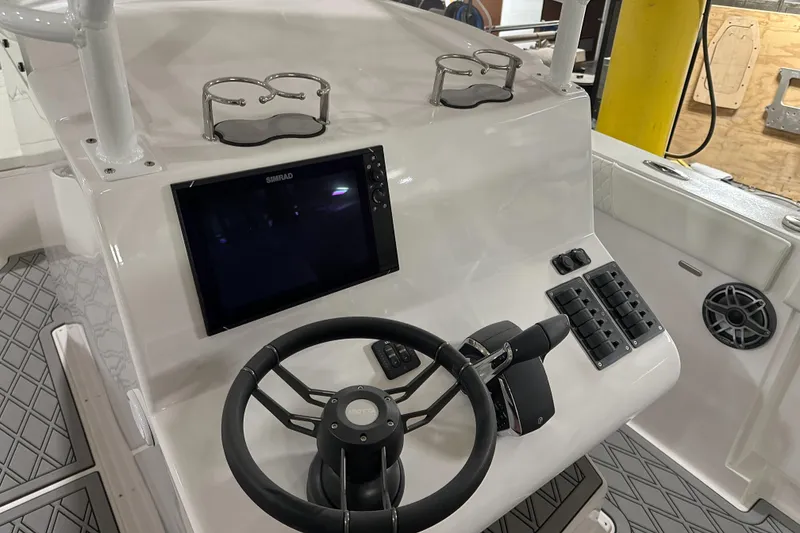 Slide: The Image of 2026 Hustler 288 CC boat dashboard with steering wheel, touchscreen, and controls. - 25