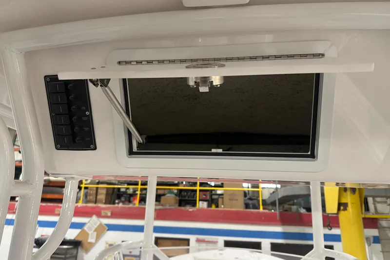 Slide: The Image of 2026 Hustler 288 CC boat interior with open hatch and control panel. - 26