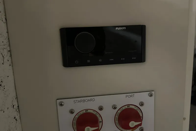 Slide: The Image of Control panel on a 2026 Hustler 288 CC boat with Fusion audio system. - 28