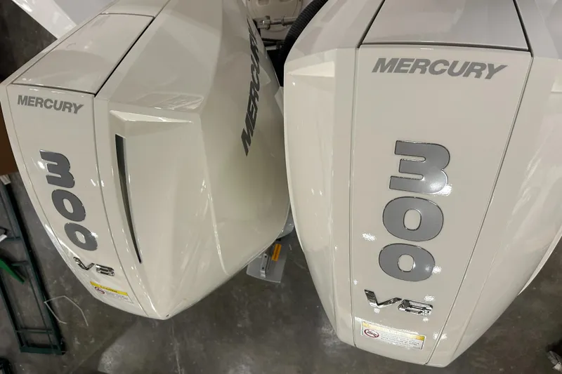 Slide: The Image of Twin Mercury 300 V8 outboard engines on a 2026 Hustler 288 CC boat. - 9