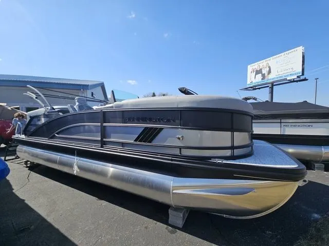 Slide: The Image of 2025 Bennington M Quad Bench 22 MFB pontoon boat displayed outdoors. - 1
