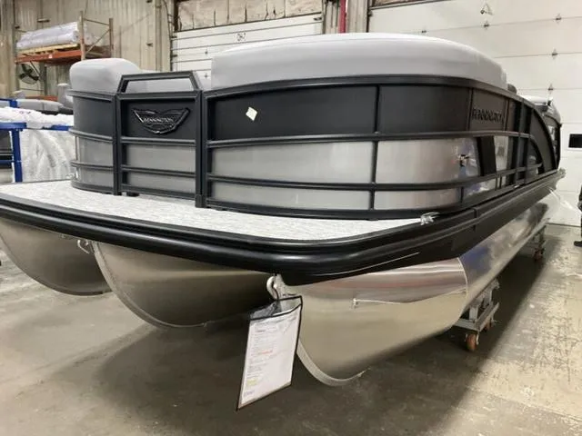 Slide: The Image of 2025 Bennington M Quad Bench 22 MFB pontoon boat in a warehouse setting. - 13