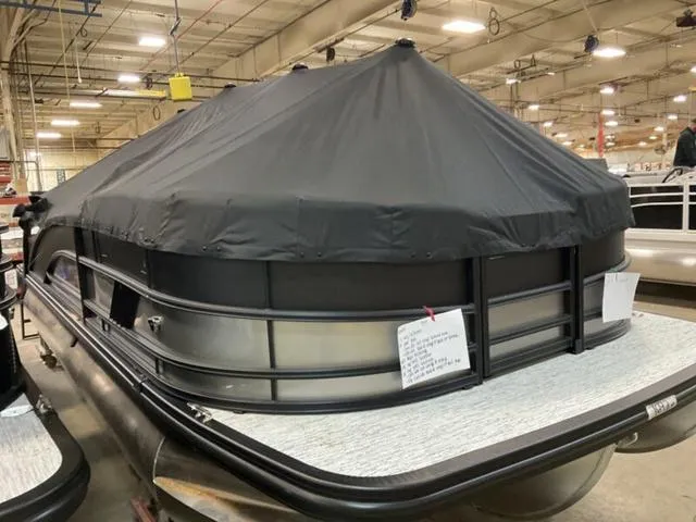 Slide: The Image of 2025 Bennington M Quad Bench 22 MFB pontoon boat with cover in a warehouse. - 14